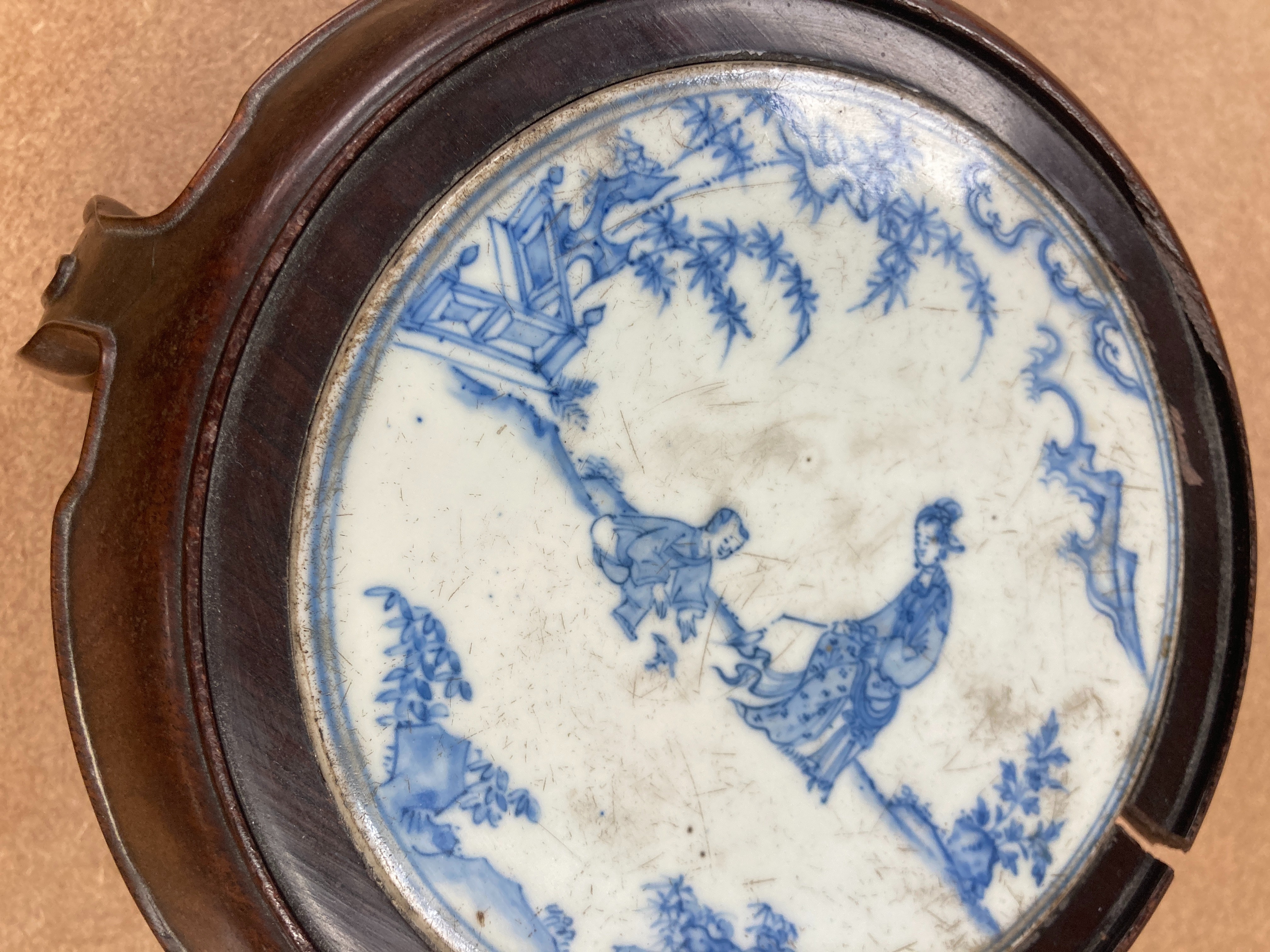 A 19th century Chinese blue and white circular tile inset hongmu stand, 22cm